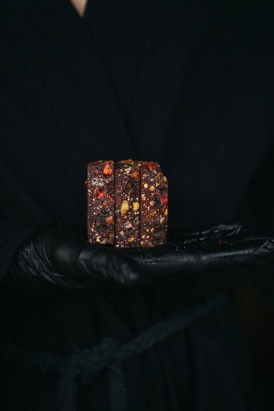 Hands Black Gloves Holding Chocolate Bars Mixed Nuts Fruits Black Stock Image