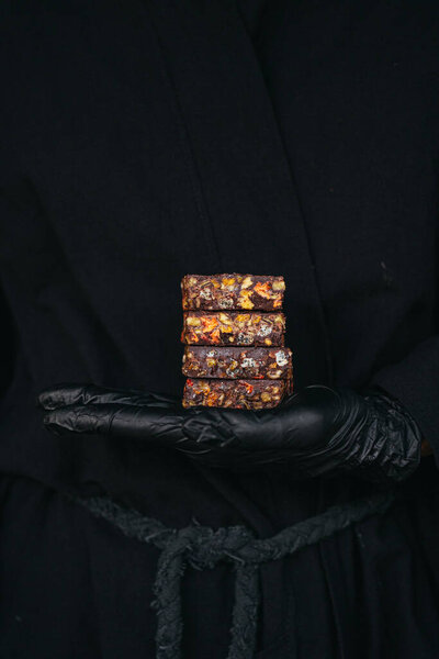 Hands Black Gloves Holding Chocolate Bars Mixed Nuts Fruits Black Royalty Free Stock Images