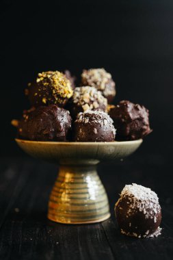 Karanlık arka planda tabaktaki çikolatalı mantarların durgun hayatı. Yüksek kalite fotoğraf