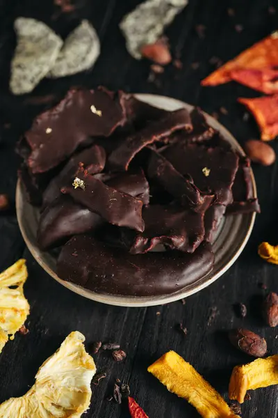 A still life of assorted dehydrated fruits in chocolate. High quality photo