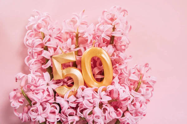Number Fifty Golden Celebration Birthday Candle Pink Flowers Background Years — Stok Foto