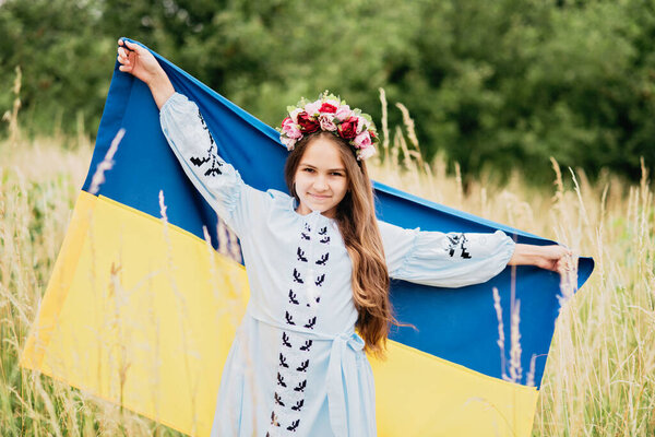Ukraines Independence Flag Day. Constitution day. Ukrainian child girl in embroidered shirt vyshyvanka with yellow and blue flag of Ukraine in field. flag symbols of Ukraine. Kyiv, Kiev day