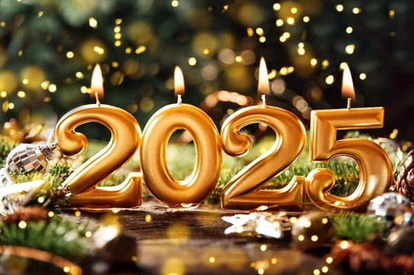 Holiday background Happy New Year 2025. Numbers of year 2025 made by gold burning candles on bokeh festive sparkling background. celebrating New Year holiday, close-up. Space for text