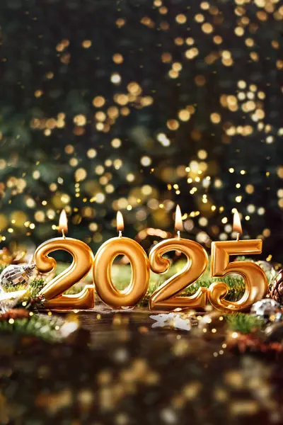 Holiday background Happy New Year 2025. Numbers of year 2025 made by gold burning candles on bokeh festive sparkling background. celebrating New Year holiday, close-up. Space for text
