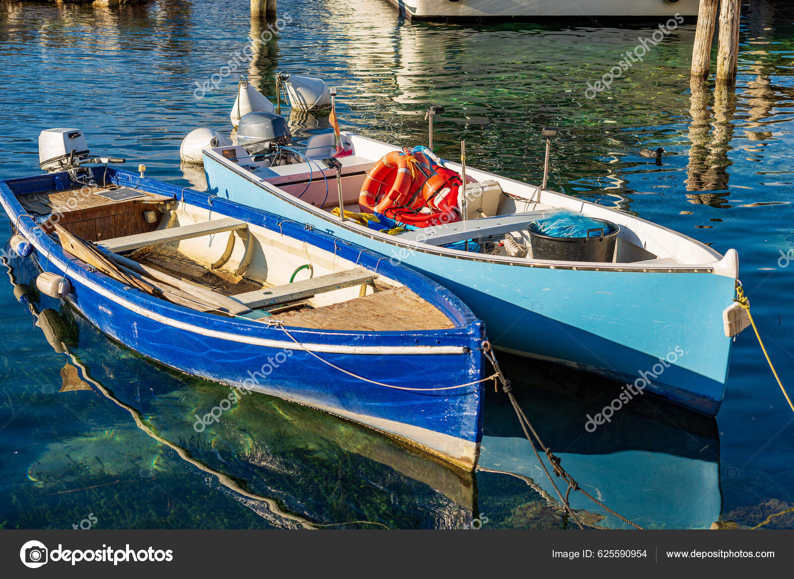 Closeup Two Small Wooden Fishing Boats Moored Small Port Malcesine Stock  Photo by ©catalby 625590954