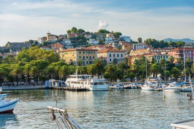 Cityscape of La Spezia view from the port with many boats moored and a ferry to the Cinque Terre, tourist resort on the coast of the Gulf of La Spezia, Liguria, Italy, Europe.