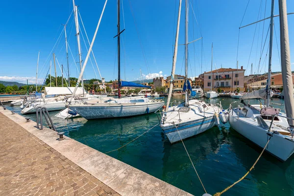 Small port of the village of Bardolino with many boats moored. Tourist resort on the coast of Lake Garda (Lago di Garda). Verona province, Veneto, Italy, southern Europe.