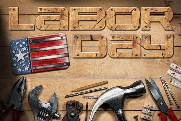 Labor Day national holiday concept. Group of work tools on a wooden background with text Labor Day and a metal national flag of the United States of America, USA (American flag).