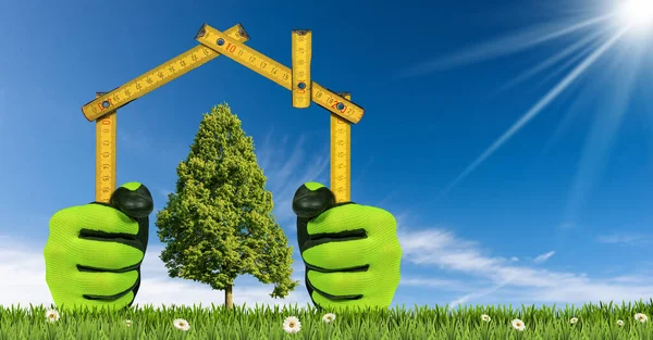 Design or project concept of an ecological house. Hands with work gloves holding a folding ruler in the shape of a house, on a green meadow with flower and a green tree. Clear blue sky on background.