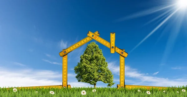 Design or project concept of an ecological house. Folding ruler in the shape of a house, on a green meadow with a single tree. Clear blue sky and sunbeams on background.