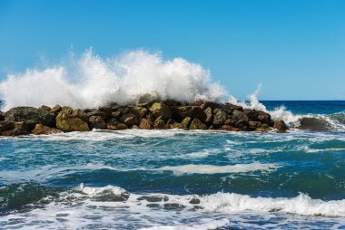 Büyük beyaz deniz dalgaları kayalara çarpıyor. Framura 'nın küçük bir köyü yakınlarındaki Breakwater. La Spezia, Liguria, İtalya, Avrupa. Akdeniz.