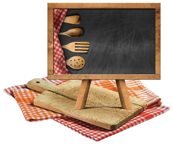 Old wood cutting board and empty blackboard with wooden kitchen utensils and copy space, on checkered tablecloths, red, orange and white. Isolated on white background, photography.