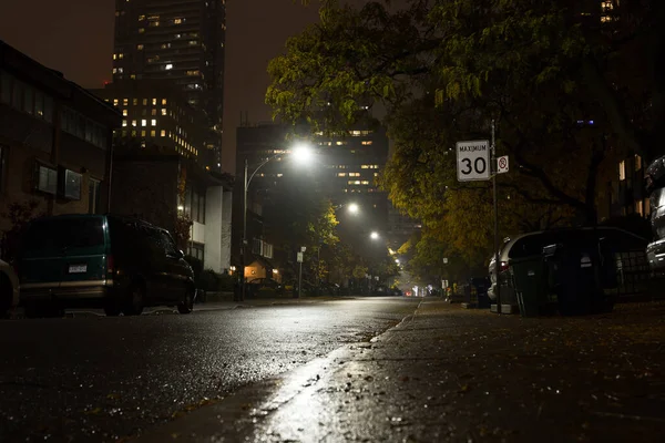 Autumn night street after rain - cars, houses, night lights illumination. Toronto, Ontario, Canada