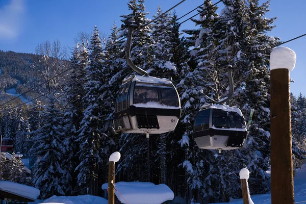 stock image Mountain lift, skiing and snowboarding sports and recreation. Ski resort in Canada. Cabin Cableway