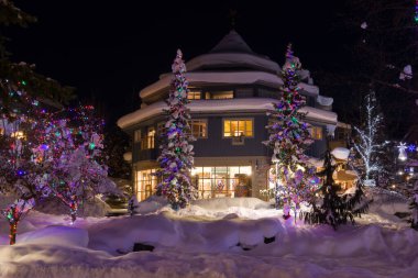 Bir dağ köyünde muhteşem bir akşam. Kar yığınları, Noel ışıkları, gece ışıkları, karla kaplı evler. Sihirli bir kış. 