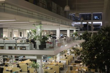 Üzerinde masaüstü duran bilgisayar tablolarından oluşan rahat işyerleri olan modern açık uzay bürosu