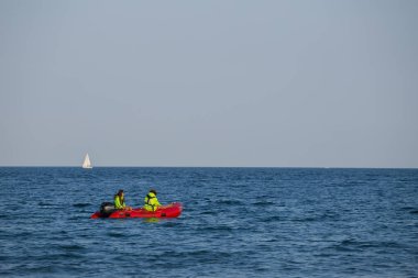  Two lifeguards in a lifeboat patrol the beach. Safety on the water. Special services. sailing in an inflatable boat to rescue people in distress.