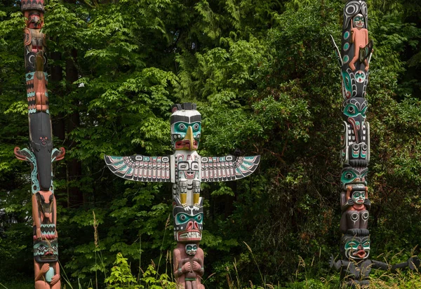 Wooden totem poles in Stanley Park. First Nations culture, travel, national art Vancouver, British Columbia, Canada