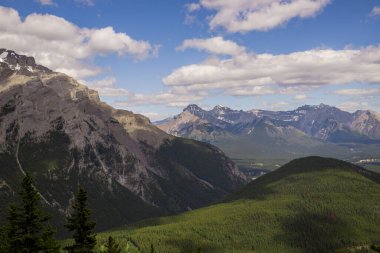  Alpine mountain landscape with snow-capped peaks and coniferous forest in Banff National Park, Alberta, Canada