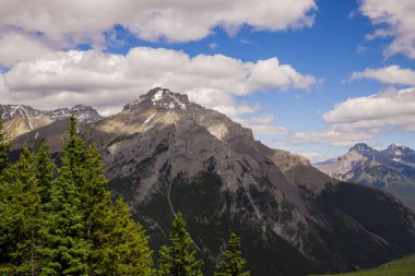  Alpine mountain landscape with snow-capped peaks and coniferous forest in Banff National Park, Alberta, Canada