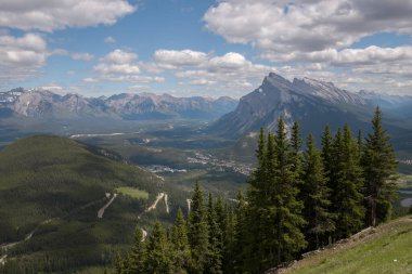 Natural landscape - Bow River Valley, Rocky Mountains, coniferous forest and beautiful sky with clouds. Summer tourism in the mountains