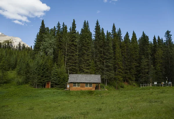 The house of mountain rescuers in the forest. Old wooden house on the background of a coniferous forest. Tourism in the mountains.