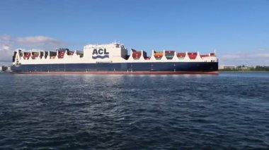 Konteynırlarla dolu bir kargo gemisi limandan ayrılıyor. Deniz yoluyla kargo taşıma sistemi. Halifax, Nova Scotia, Kanada