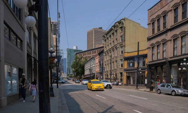 stock image Urban view of Downtown Vancouver. The general plan of the street - old and modern buildings, roads, commercial establishments on sunny summer day. 