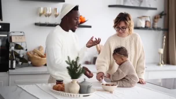 Happy Interracial Family Plays Baby Daughter Kitchen Christmas Decorations Father — Stock Video