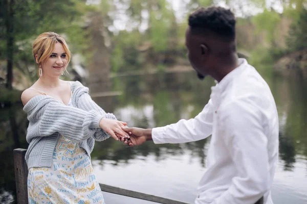 인종간의 남녀는 서로를바라보며 호수의 배경에 미소를 짓는다 인종간 관계와 연합에 — 스톡 사진