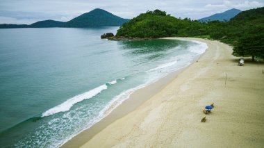 Vermelha do Norte Beach in Ubatuba - SP - with calm waters, known for surfing, nature on a cloudy day, tropical forest, landscape and drone photography, with aerial view in high resolution clipart