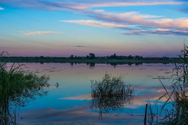 Beautiful landscape of sunset, multicolored sky, lake