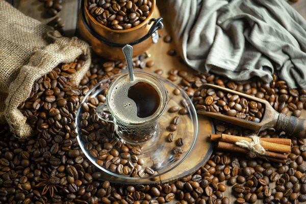 Espresso coffee with coffee beans on old background.