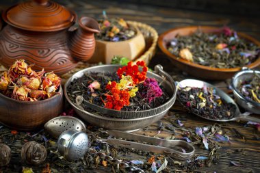 Eski bir arka planda kaşıkta kuru çay yaprakları.