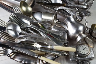 Eski bir arkaplanda gümüş eşyalar.