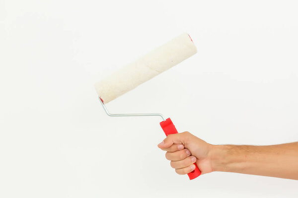 Woman hand holding a paint roller isolated on a white background.
