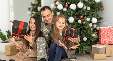 military father and children near christmas tree.