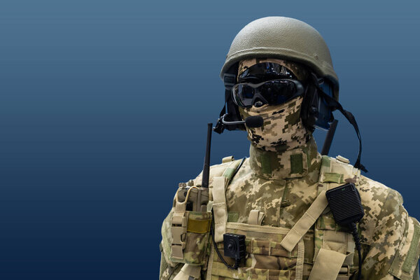Elite member of Army rangers in helmet and dark glasses. Studio shot, dark black background, looking at camera, dark contrast.