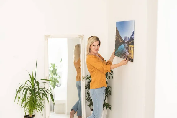 Modern Home Interior Domestic Decor Smiling Young Woman Hanging Painting — 图库照片
