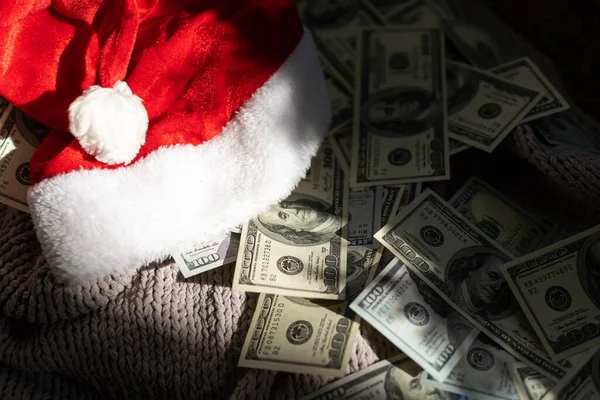 stock image Santa Claus hat on money american hundred dollar bills - horizontal.