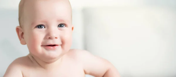 Niedliches Lächelndes Baby Auf Einer Grauen Couch — Stockfoto