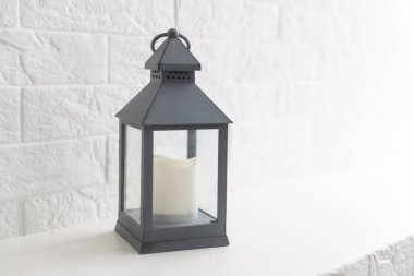 decorative flashlight close-up on the background of a white brick wall, copy space