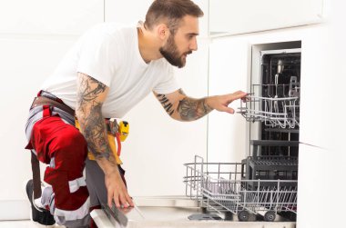 Craftsman repairs broken dishwasher.