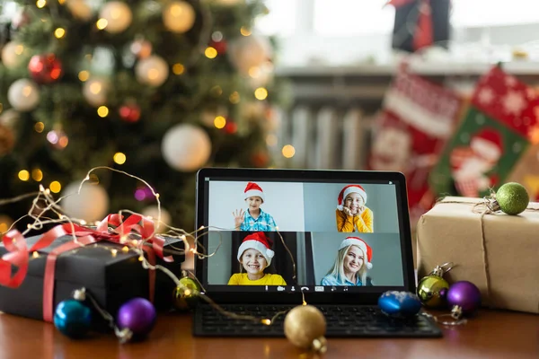 Big family singing christmas song at tablet camera during online video call. Smiling parents and children. Joyful family congratulating relatives with happy new year online.
