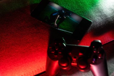 Gamer work space concept. gaming set up. top view of a gaming gear, joystick and a smartphone.