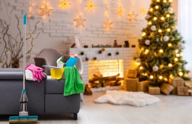 Noel 'den önce temizlik. Çok renkli temizlik malzemeleri. Süngerler, paçavralar ve spreyler modern ev arka planına karşı şenlikli dekorasyonlar