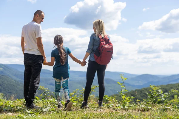 stock image Family stay on the top of mountain, looking on the beautiful view
