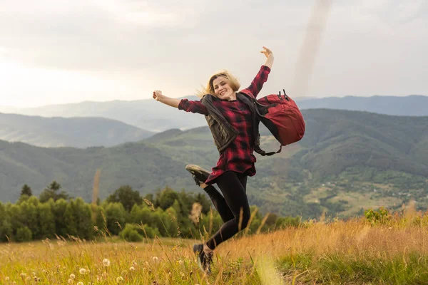 stock image Freedom traveler woman on the top of mountains enjoy a wonderful nature. Yound girl on peak mountain with perfect view mountains. travel concept.