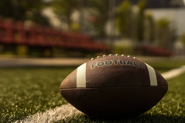 American football on football field background.