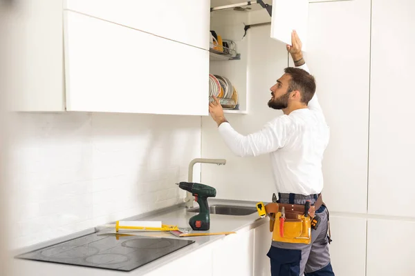 Repairman Overalls Repairing Cabinet Hinge Kitchen — Stock Photo, Image